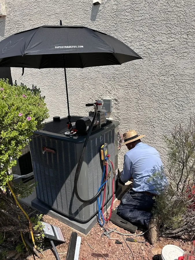 HVAC technician performing outdoor AC maintenance in Lomita